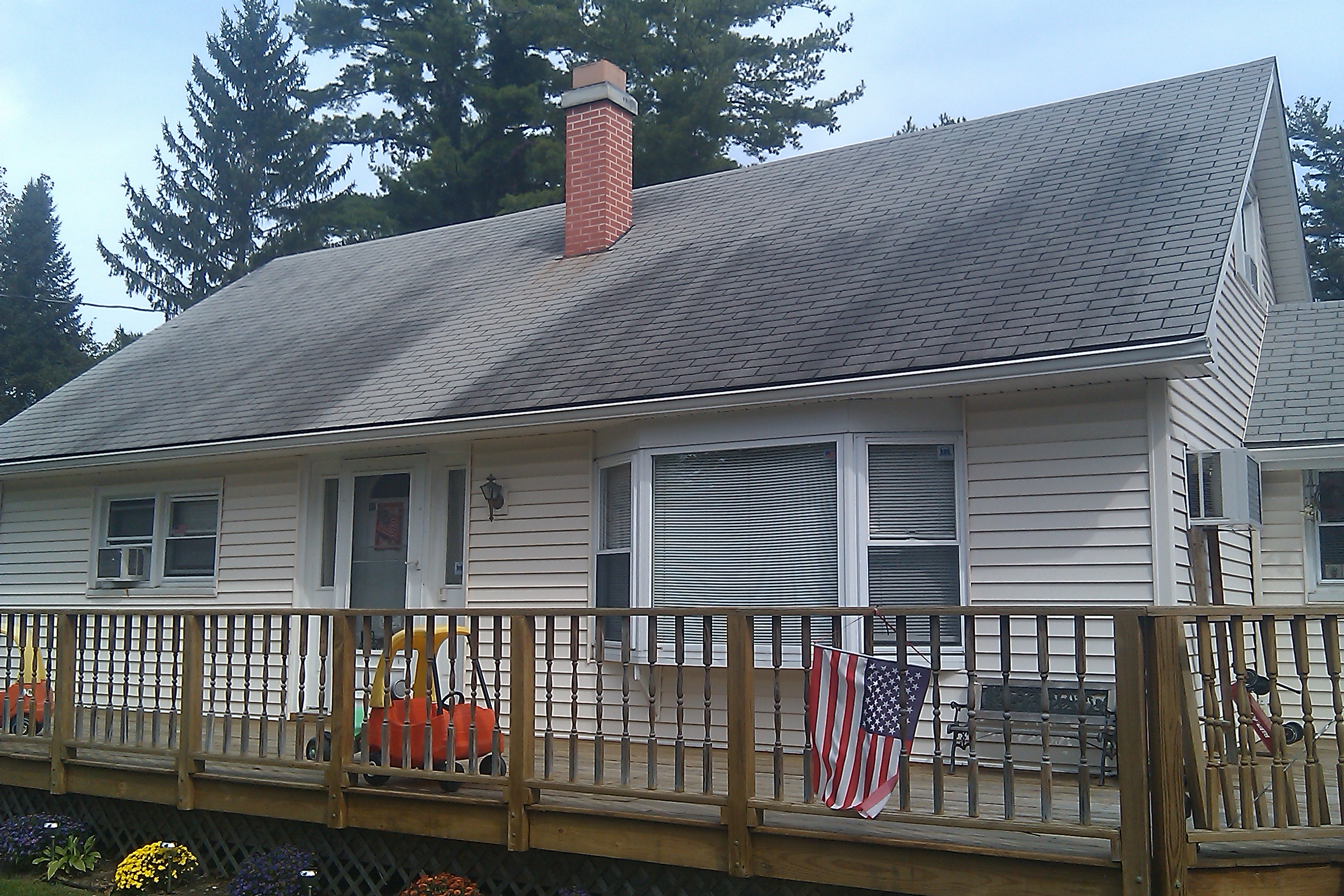 House roof before professional cleaning showing algae and staining