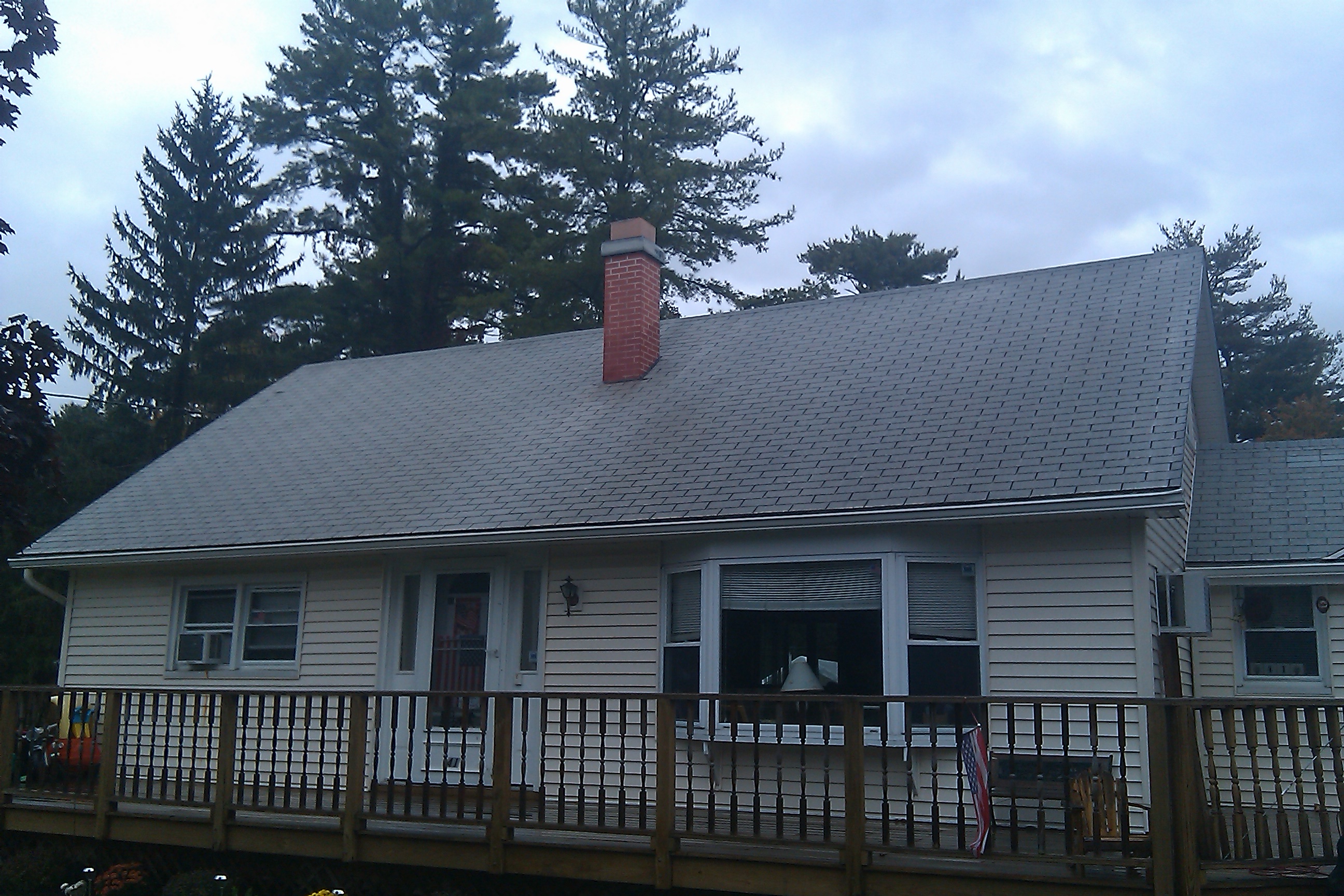 Same house roof after professional cleaning showing restored appearance