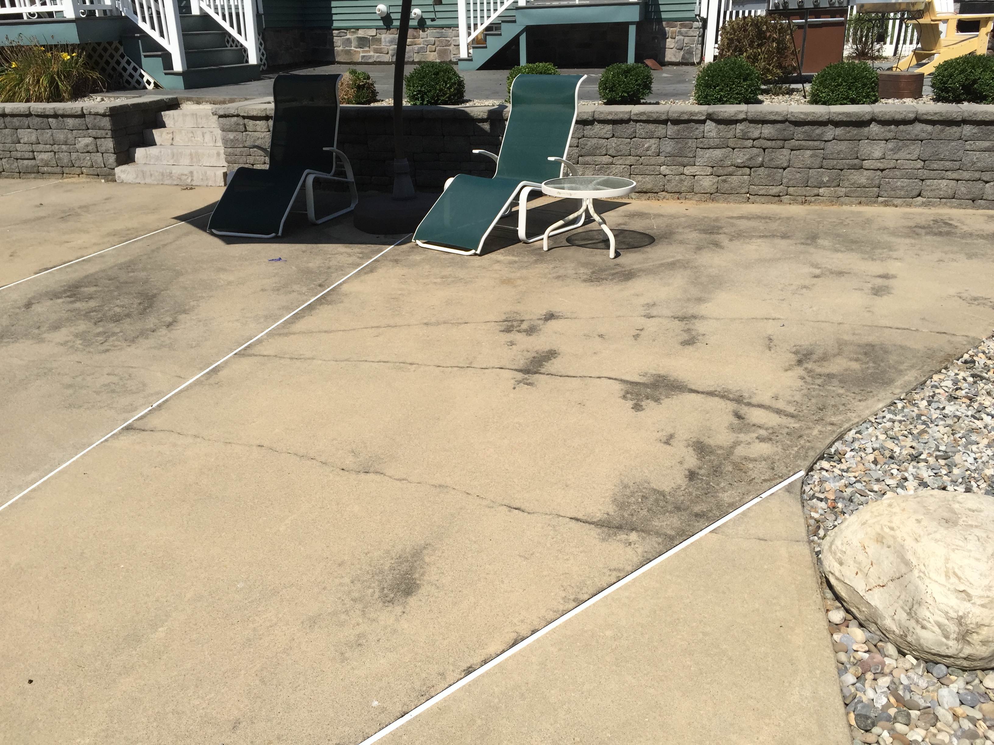 Concrete patio before power washing showing stains and dirt
