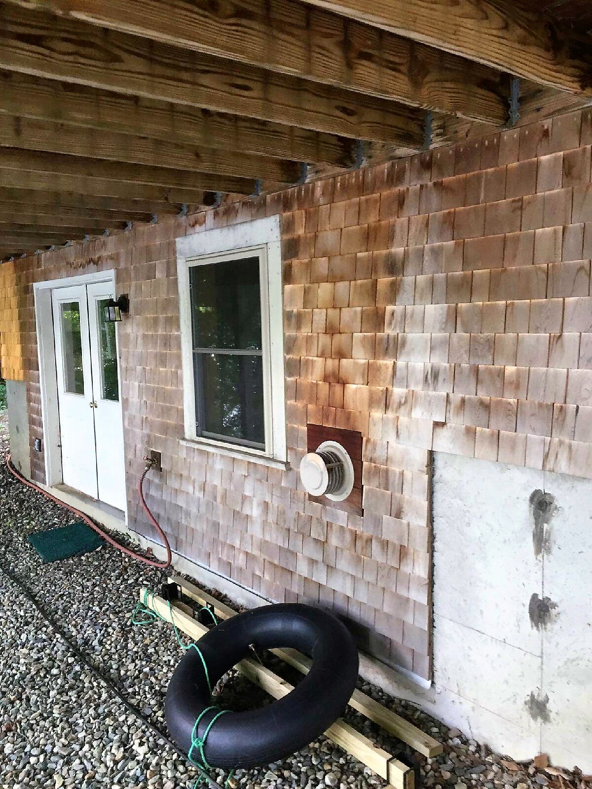 Cedar siding before cleaning - weathered and dark