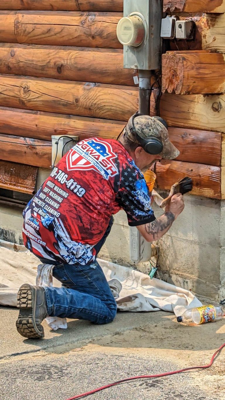 Professional craftsman applying chinking material between log joints