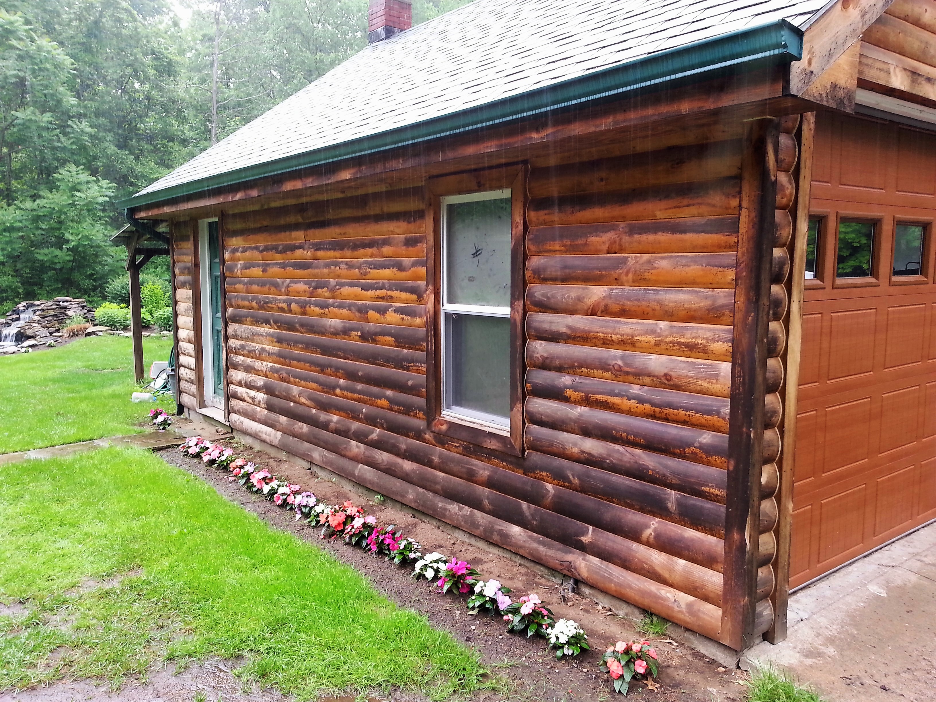 Log cabin siding before cleaning - weathered and dark